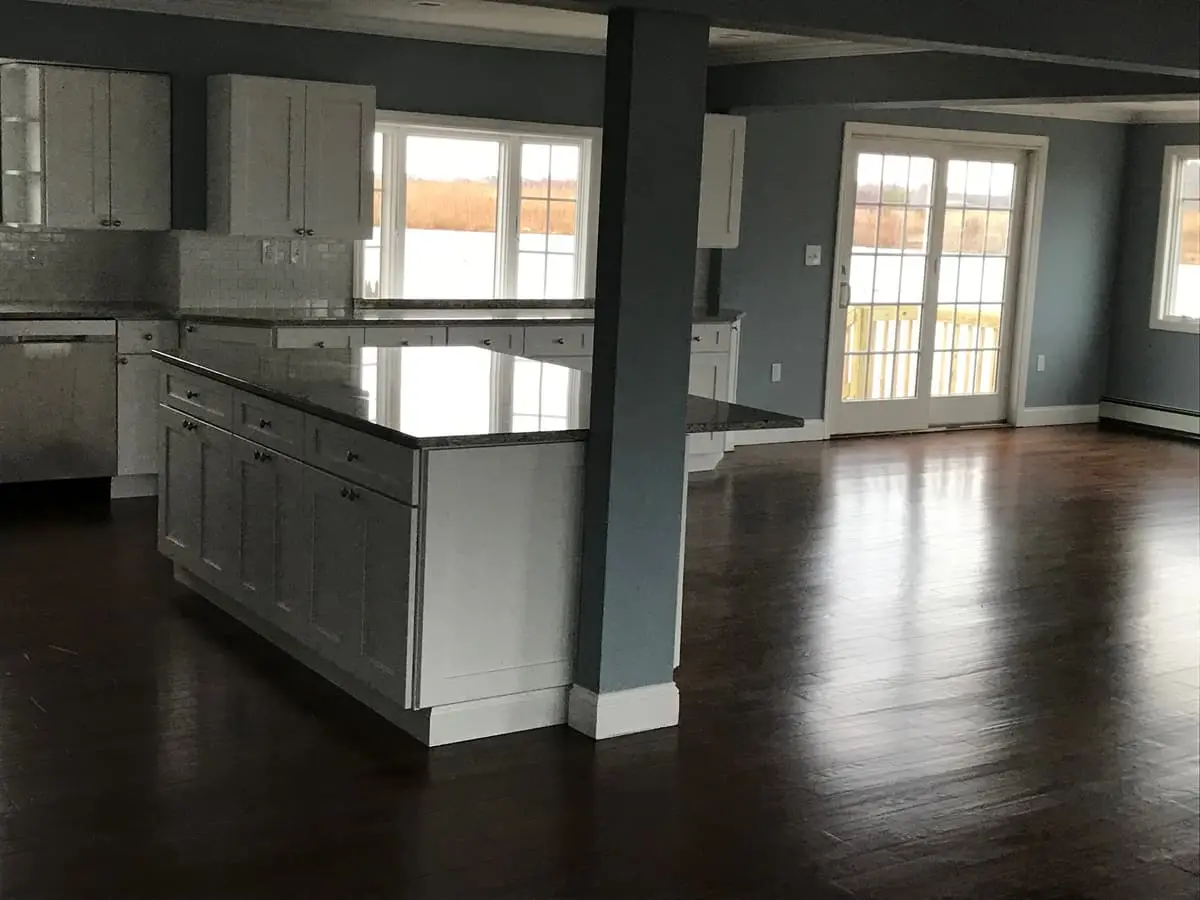 Selling a multi-family house in Amityville: finished kitchen island with dark wood floors
